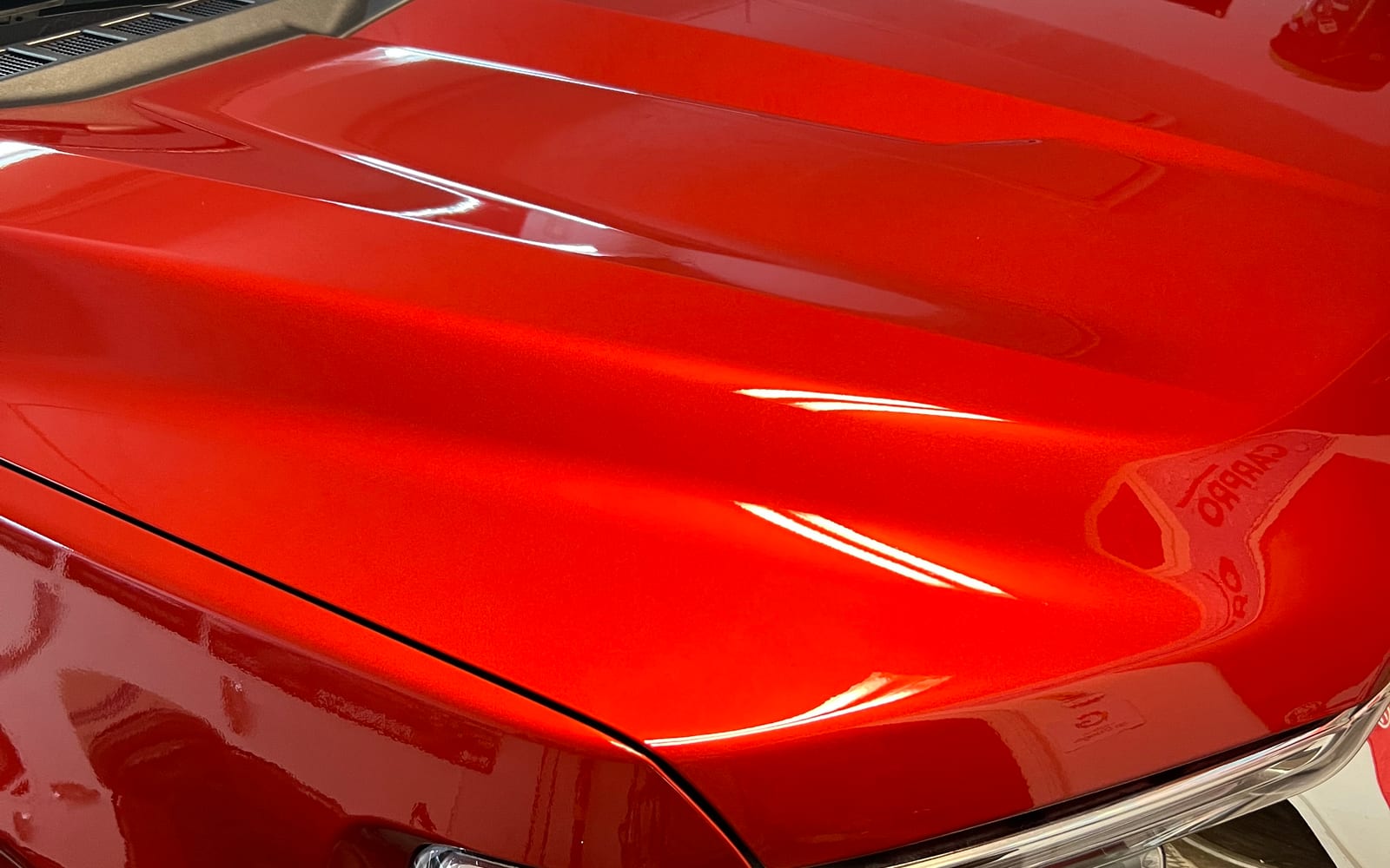 Deep, wet-look reflection on freshly coated paint